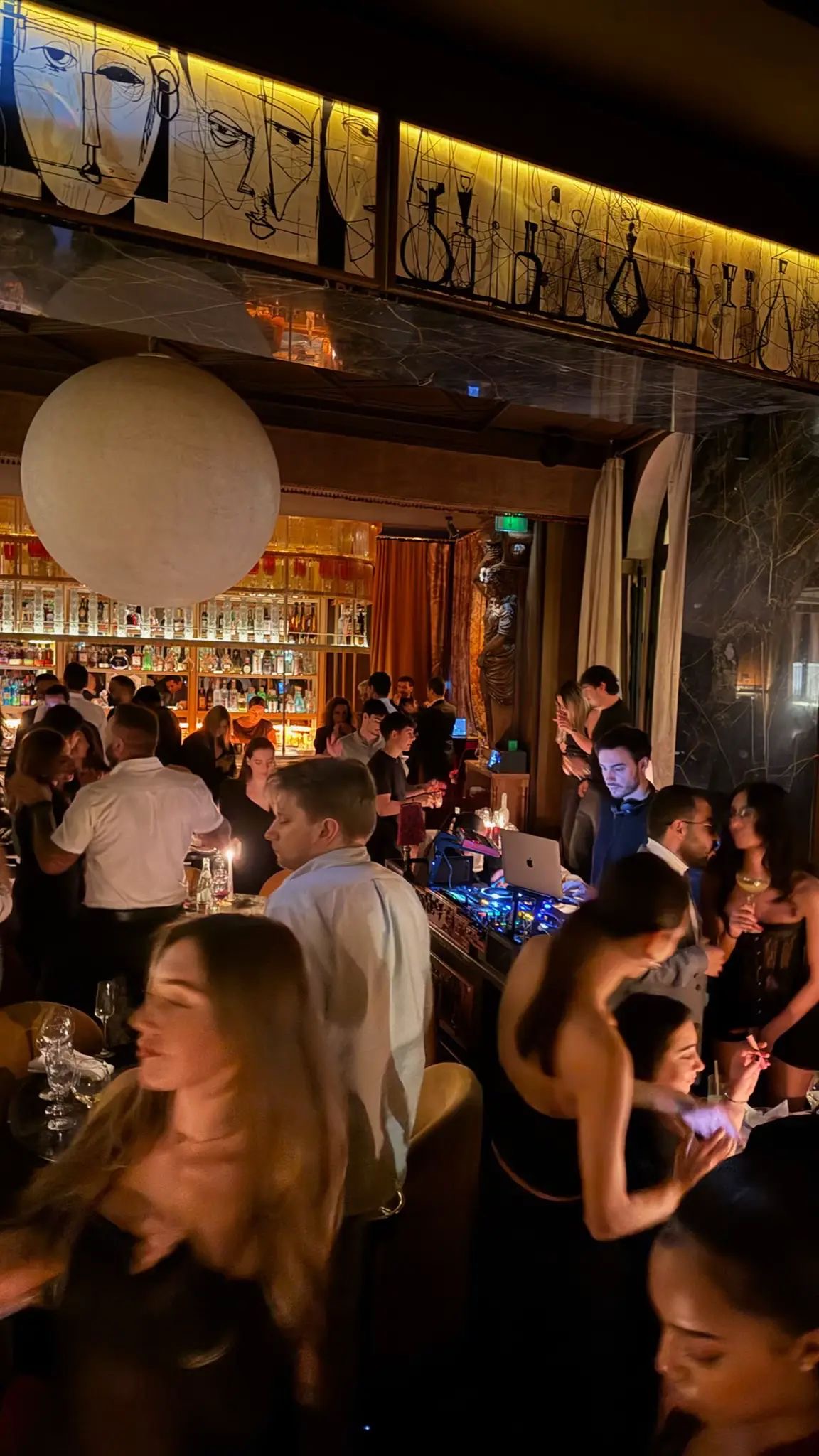 A lively nightlife venue with guests and a DJ